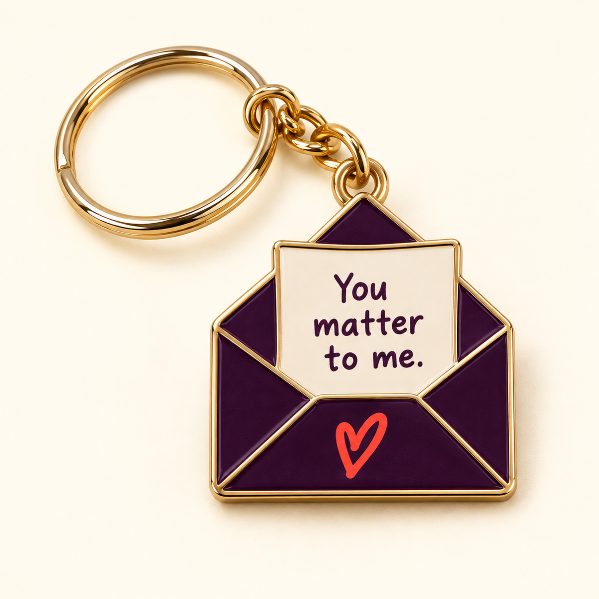 Plum envelope keychain with a cream You matter to me note, coral heart, and gold-tone edging and keyring